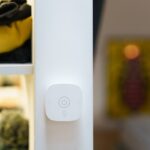 Close-up of a smart home light switch in a modern room interior, showcasing contemporary technology.
